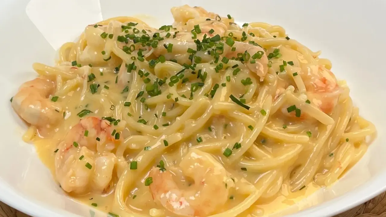 Spaghetti cremosi con gamberi e erba cipollina, una deliziosa carbonara di mare.