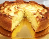 Una deliziosa torta di mele, dorata e soffice, con fette di mela disposte a spirale sulla superficie.