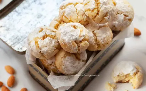 Biscotti con farina di mandorle, soffici e profumati, cosparsi di zucchero a velo, pronti per essere gustati.
