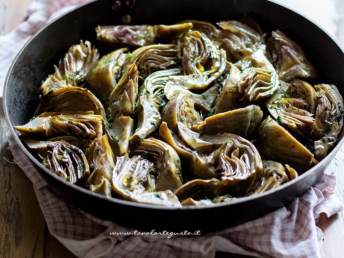 Carciofi in padella, teneri e profumati, cotti lentamente con erbe aromatiche. Un contorno saporito e invitante.