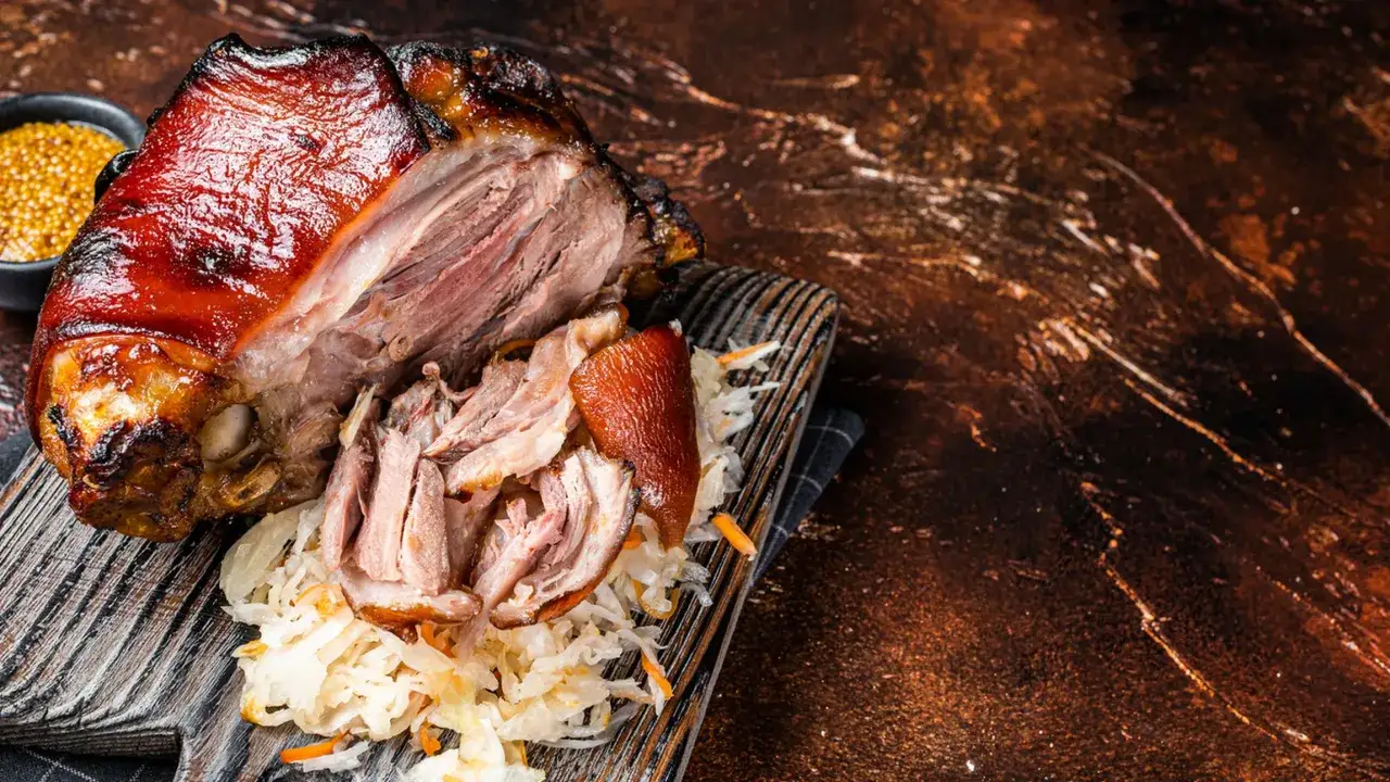 Succulento pulled pork cotto lentamente, servito con crauti e senape in grani. Una ricetta perfetta per un pasto saporito.